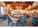 Elegant dining room with wood beams, a fireplace, and stylish seating at 8710 E Lost Gold Cir, Gold Canyon, AZ 85118