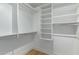 Spacious walk-in closet with built-in shelves and hanging rods at 21320 N 56Th St # 2159, Phoenix, AZ 85054