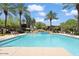 Inviting community pool with palm trees and seating at 21320 N 56Th St # 2159, Phoenix, AZ 85054
