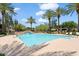 Inviting community pool surrounded by palm trees and lounge chairs at 21320 N 56Th St # 2159, Phoenix, AZ 85054