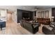 Living room with leather furniture, large TV, and decorative wall art at 17663 W Straight Arrow Ln, Surprise, AZ 85387