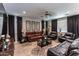 Spacious living room featuring a brown leather sectional sofa and a coffee table at 17663 W Straight Arrow Ln, Surprise, AZ 85387