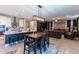 Modern kitchen with island and breakfast bar, open to living room at 17663 W Straight Arrow Ln, Surprise, AZ 85387