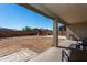 Large backyard with covered patio, playset, and basketball hoop at 17663 W Straight Arrow Ln, Surprise, AZ 85387