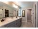 Modern bathroom with double vanity and walk in shower at 17663 W Straight Arrow Ln, Surprise, AZ 85387