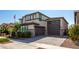 Two-story home with stone accents and landscaped yard at 17663 W Straight Arrow Ln, Surprise, AZ 85387