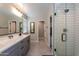 Modern bathroom with double vanity and a large mirror at 17663 W Straight Arrow Ln, Surprise, AZ 85387