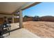 Spacious backyard with covered patio, playset, and trampoline at 17663 W Straight Arrow Ln, Surprise, AZ 85387