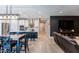 Open floor plan kitchen and living area with island, modern appliances, and dark cabinetry at 17663 W Straight Arrow Ln, Surprise, AZ 85387