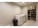 Laundry room with washer, dryer, and shelving at 17663 W Straight Arrow Ln, Surprise, AZ 85387