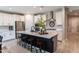 Modern kitchen with island, stainless steel appliances, and breakfast bar at 17663 W Straight Arrow Ln, Surprise, AZ 85387