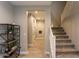 Modern staircase with a white railing and carpeted steps at 17663 W Straight Arrow Ln, Surprise, AZ 85387