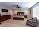 Main bedroom with king bed, chair, and large dresser at 17663 W Straight Arrow Ln, Surprise, AZ 85387