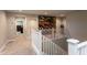 Upstairs hallway with white railings and a toy display at 17663 W Straight Arrow Ln, Surprise, AZ 85387