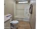 Clean bathroom with tub, toilet and wood-look flooring at 11596 W Sierra Dawn Blvd # 28, Surprise, AZ 85378