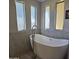 Spa-like bathroom with a freestanding soaking tub and large windows at 11596 W Sierra Dawn Blvd # 28, Surprise, AZ 85378
