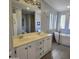 Bathroom with double vanity and large mirror reflecting a soaking tub at 11596 W Sierra Dawn Blvd # 28, Surprise, AZ 85378