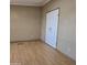 Simple bedroom with laminate wood flooring and double door closet at 11596 W Sierra Dawn Blvd # 28, Surprise, AZ 85378