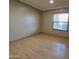 Spacious bedroom with wood flooring and large window at 11596 W Sierra Dawn Blvd # 28, Surprise, AZ 85378