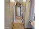 Long hallway with light wood flooring and access to bedrooms at 11596 W Sierra Dawn Blvd # 28, Surprise, AZ 85378