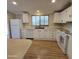 Bright kitchen with white cabinets, wood flooring, and modern appliances at 11596 W Sierra Dawn Blvd # 28, Surprise, AZ 85378