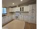 Galley kitchen with white cabinets and a built in range at 11596 W Sierra Dawn Blvd # 28, Surprise, AZ 85378