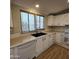 Kitchen with white cabinets and laminate countertops at 11596 W Sierra Dawn Blvd # 28, Surprise, AZ 85378