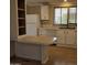 Kitchen with white cabinets, laminate countertops, and built-in shelving at 11596 W Sierra Dawn Blvd # 28, Surprise, AZ 85378