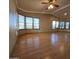 Spacious living room with laminate flooring, large windows, and ceiling fan at 11596 W Sierra Dawn Blvd # 28, Surprise, AZ 85378