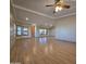 Spacious living room with laminate flooring, large windows, and ceiling fan at 11596 W Sierra Dawn Blvd # 28, Surprise, AZ 85378