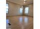 Spacious living room featuring light laminate flooring and multiple windows at 11596 W Sierra Dawn Blvd # 28, Surprise, AZ 85378