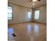 Spacious living room featuring light laminate flooring and multiple windows at 11596 W Sierra Dawn Blvd # 28, Surprise, AZ 85378
