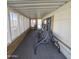 Relaxing screened porch with a double swing and wood-like flooring at 11596 W Sierra Dawn Blvd # 28, Surprise, AZ 85378