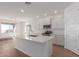 Modern kitchen featuring white cabinets, quartz countertops and island at 25227 N 131St Dr, Peoria, AZ 85383