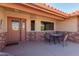 Brick patio with seating area and entrance to the home at 11009 E Keats Ave, Mesa, AZ 85209