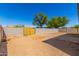 Large backyard with block wall and small patio at 9290 W Troy Dr, Arizona City, AZ 85123