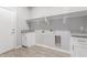 Bright laundry room with built-in shelving and cabinets at 9290 W Troy Dr, Arizona City, AZ 85123