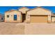 Tan stucco home with a two-car garage and landscaped yard at 9290 W Troy Dr, Arizona City, AZ 85123