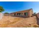 Spacious backyard with stucco home and desert landscaping at 9290 W Troy Dr, Arizona City, AZ 85123