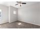 Spacious bedroom with ceiling fan and window at 9290 W Troy Dr, Arizona City, AZ 85123