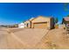 Tan stucco home with a two-car garage and paved driveway at 9290 W Troy Dr, Arizona City, AZ 85123