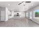 Open concept kitchen with white cabinets, granite countertops, and stainless steel appliances at 9290 W Troy Dr, Arizona City, AZ 85123
