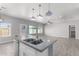 Open concept kitchen with island, white cabinets, and granite countertops at 9290 W Troy Dr, Arizona City, AZ 85123