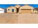 Tan stucco home with a two-car garage and landscaped yard at 9290 W Troy Dr, Arizona City, AZ 85123