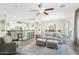 Spacious living room with hardwood floors, neutral color palette, and access to kitchen at 8290 E Tailspin Ln, Scottsdale, AZ 85255