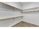 Large walk-in closet with ample shelving and hanging space at 42929 W Castle Cove Cir, Maricopa, AZ 85138
