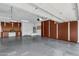 Spacious garage with storage cabinets and epoxy flooring at 42929 W Castle Cove Cir, Maricopa, AZ 85138