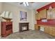 Home office with built-in wooden desk, fireplace, and nautical decor at 42929 W Castle Cove Cir, Maricopa, AZ 85138