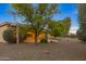 Spacious backyard with covered patio, gravel landscaping, and mature trees at 42929 W Castle Cove Cir, Maricopa, AZ 85138
