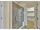 Bathroom with a walk-in shower and access to the closet at 42929 W Castle Cove Cir, Maricopa, AZ 85138